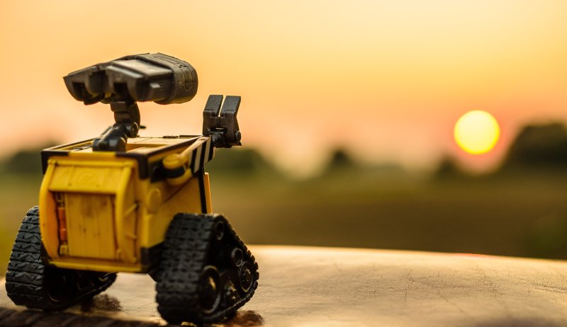 Wall-e robot waving in a sunset