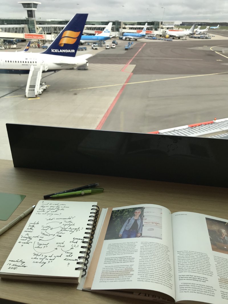 Window view overlooking airplanes landing and taking off.