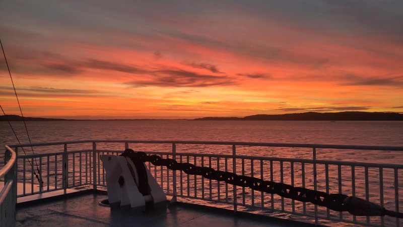 view of sunset from a ship looking out over an ocean