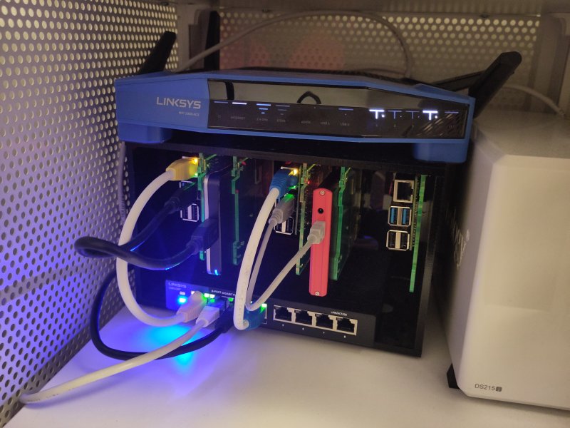 a small raspberry pi computer connected, by cable to a switch, and then connected to an internet router